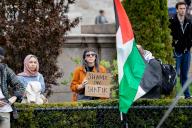 NEW YORK, NEW YORK - APRIL 19: A pro-Palestinian activists holds a sign that says, "Shame on Shafik," the surname of Columbia University president Nemat Shafik, inside the campus of Columbia University for a third day to protest the university