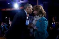 US President Barack Obama shakes hands with former Rep. Gabby Giffords, D-Ariz, during the commercial break of a live town hall event with CNN