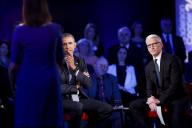 US President Barack Obama (C) listens to a question during a live town hall event with CNN
