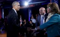 US President Barack Obama shakes hands with former Rep. Gabby Giffords, D-Ariz, during the commercial break of a live town hall event with CNN