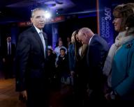 US President Barack Obama walks after shaking hands with former Rep. Gabby Giffords, D-Ariz, during the commercial break of a live town hall event with CNN