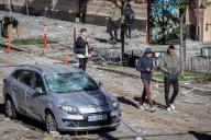 People walk past a damaged car after a Russian missile attack in central Kyiv. Explosions have been reported in several districts of the Ukrainian capital Kyiv on October 10, 2022. At least 11 people died and dozens injured as a result of Russian rocket attacks targeting cities across Ukraine. (Photo by Oleksii Chumachenko / SOPA Images/Sipa USA