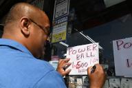 A store manager uses a red pen to update notes on his widow for the Powerball Jackpot that went from $1.5 billion to $1.6 billion, in the Queens borough of New York City, NY, November 4, 2022. The record amount has been set because 39 straight drawings since Aug. 3 have not seen a winner; the estimated lump sum cash payout after taxes is estimated to be more than $740 million. (Photo by Anthony Behar/Sipa USA
