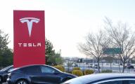 Vehicles on Interstate 580 drive past the Tesla logo. Tesla aims to start production of affordable new EVs by early 2025 (Photo by Gabe Ginsberg \/ SOPA Images\/Sipa USA