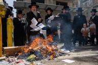 A Jewish Rabbi is seen throwing papers to the fire. During the Biur Chametz, religious Jews fulfill their obligation to inspect their homes for any leaven and eliminate it before the night of Passover. In ultra-Orthodox cities in Israel, fires are set up in major locations in the city for this purpose, where people bring their bread leftovers to burn the leaven. During the seven days of Passover, they are prohibited from eating or possessing any leaven, symbolizing the dough the Israelites did not have time to allow to rise before the Exodus from Egypt. Biur Chametz, also known as \'the burning of the leavened goods,\' is a Jewish ceremonial ritual involving the burning of leavened foods (chamets) to mark the start of Passover. (Photo by Sharon Eilon \/ SOPA Images\/Sipa USA