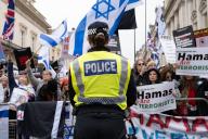 A female Metropolitan Police Officer stands in front of counter protestors during the rally. After several months of pro Palestinian marches held in Central London anti Hamas and pro Israeli demonstrations have started to grow in size and support. Members of the Jewish and British Israeli community have held counter protests along the route of the large Palestinian marches held every two weeks in Central London. Rows of Police and barriers separate the two groups. The Palestinian groups have stated they will continue to march until there is a permanent cease fire in Gaza. With growing support the counter protestors are expected to continue until Hamas is completely destroyed and all hostages are returned. (Photo by James Willoughby \/ SOPA Images\/Sipa USA