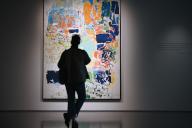 A visitor stands in front of artist Joan Mitchell\'s painting titles \'Noon" - estimated at $15M to $20M, on opening day of public exhibitions for Sotheby\'s marquee contemporary and Modern art auctions, New York, NY, May 3, 2024. (Photo by Anthony Behar\/Sipa USA