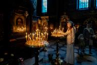 Orthodox believer set candles in St. Volodymyr Cathedral on the eve of the celebration of Easter amid Russian invasion of Ukraine. (Photo by Sergei Chuzavkov \/ SOPA Images\/Sipa USA