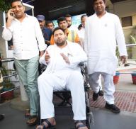 PATNA, INDIA - MAY 6: RJD leader Tejashwi Yadav arrives on wheelchair at the Jaiprakash Narayan Airport on May 6, 2024 in Patna, India. On his return from Araria, Yadav was so unwell that he was forced to move out on wheelchair from Patna airport. When asked by media persons, RJD leader said that he was not feeling well at all. His condition further deteriorated, he added.(Photo by Santosh Kumar\/Hindustan Times\/Sipa USA
