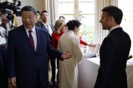 France\'s President Emmanuel Macron (R) and Chinese President Xi Jinping speak, as the French President\'s wife Brigitte and China\'s First Lady Peng Liyuan (2nd R) look at exchanged gifts, during the Chinese president\'s two-day state visit, at The Elysee Presidential Palace in Paris, France on May 6, 2024. Xi\'s two-day state visit to France is his first visit to Europe since 2019 on a trip that will also see him hold talks in Serbia and Hungary. He has said he wants to find peace in Ukraine even if analysts do not expect any major breakthrough. Photo by Ludovic Marin\/Pool\/Abaca\/Sipa