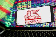 In this photo illustration, the Generali logo is seen displayed on a smartphone screen against a computer screen and its reflections displaying an illustration of stock market numbers is the company releases its Q1earning. (Photo by Dominika Zarzycka \/ SOPA Images\/Sipa USA) *** Strictly for editorial news purposes only