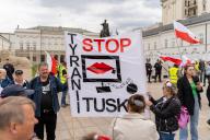 A protester carries a banner with the inscription " stop Tusk