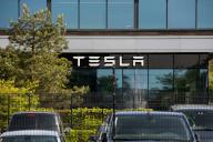 An American automotive and energy company that specialises in electric car manufacturing; Tesla, signboard seen on the Tilburg Factory & Delivery Center building