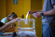 Barcelona, Spain - 12-05-2024: The hands of a man are seen close up while casting his ballot in a ballot box at a polling station in the Guinardo district, during the elections in the region of Catalonia, which could see the return of independist leaders to power. Davide Bonaldo/Sipa
