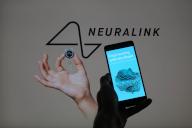 Neuralink web site image is displayed on a smartphone with Neuralink logo visible in the background in this photo illustration. Taken in Brussels, Belgium. On May 13, 2024. (Jonathan Raa / Sipa USA) *** Strictly for editorial news purposes only 