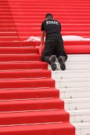 Staff members work on the red carpet roll out ahead of the 77th annual Cannes Film Festival held at the palais des Festivals on May 14, 2024 in Cannes, France. Photo by David Boyer/Abaca/Sipa