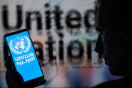 The UNRWA logo is displayed on a smartphone with United Nations visible in the background in this photo illustration. Taken in Brussels, Belgium. On May 15, 2024. (Jonathan Raa / Sipa USA) *** Strictly for editorial news purposes only 