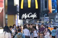 Pedestrians walk past the American multinational fast-food hamburger restaurant chain, McDonald