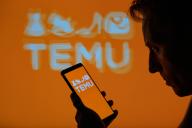 The Temu logo is displayed on a smartphone with Temu visible in the background in this photo illustration. Taken in Brussels, Belgium. On May 16, 2024. (Jonathan Raa / Sipa USA) *** Strictly for editorial news purposes only 