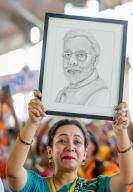 Howrah, May 12, 2024 (ANI): A Bharatiya Janata Party (BJP) supporter holds a portrait of Prime Minister Narendra Modi during a public meeting in support of party candidate from Howrah constituency Rathin Chakraborty for the Lok Sabha polls, in Howrah on Sunday. (ANI Photo via Hindustan Times/Sipa USA