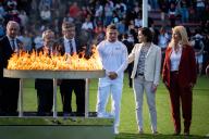 French rugby player Antoine Dupont holds the Olympic torch and French Sports and Olympics Minister Amelie Oudea-Castera and French Deputy Minister for territorial collectivities and Rurality Dominique Faure during the torch relay at the Ernest-Wallon stadium in Toulouse, south-western France, on May 17, 2024, ahead of the Paris 2024 Olympic Games. Photo by Alexis Jumeau/Abaca/Sipa