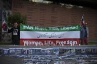 Two protesters hold a banner and flags of Iran, during a protest by the Iranian community in Madrid, which joins the global action of lighting candles in memory of the martyrs of the path of freedom and the women\'s revolution, the life, freedom. (Photo by Luis Soto \/ SOPA Images\/Sipa USA