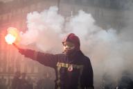 A protester seen holding a fire flare during the firefighters demonstration. Thousands of firefighters demonstrated in Paris to demand more resources, a bonus during the Olympic Games, an increase in fire bonuses and quality of life at work. (Photo by Telmo Pinto \/ SOPA Images\/Sipa USA