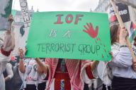 A pro-Palestine protester holds a placard calling the IOF (Israeli Occupying Forces) a "terrorist group" during the demonstration in Piccadilly Circus. Thousands of people marched in solidarity with Palestine on the 76th anniversary of the Nakba as Israel continues its attacks on Gaza. (Photo by Vuk Valcic \/ SOPA Images\/Sipa USA