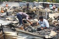 GURUGRAM, INDIA - MAY 18: People salvage charred belongings from a site where a massive fire erupted at a slum area in Medawas village sector-65 near Golf course extension road, on May 18, 2024 in Gurugram, India. (Photo by Parveen Kumar\/Hindustan Times\/Sipa USA 