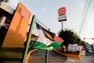 A Palestinian flag waves during the demonstration. The "Comida no Bombas" collective protested peacefully by giving away water and food outside one of the branches of the "Burger King" chain. The action corresponds to a global call to boycott companies that have directly or indirectly supported Israel