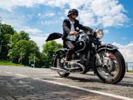 A man wearing a tuxedo jacket rides a motorbike. The Distinguished Gentlemans Ride unites classic and vintage-style motorcycle riders worldwide to raise funds and awareness for prostate cancer research and mens mental health. In Nijmegen more than two hundred motorcycle riders, raised around 30.000. The Distinguished Gentleman