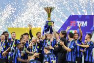 Lautaro Martinez of FC Internazionale lifts the trophy as the team celebrates it
