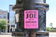 Signs protesting Joe Biden coming to Chicago for the upcoming Democratic National Convention can be seen posted on a street light in the Bucktown neighborhood of Chicago on May 25, 2024. The woman-led, anti-war organization CODEPINK has a DISRUPT THE DNC: Chicago action event planned during the upcoming DNC National Convention in Chicago to protest the USA