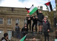 Young protesters climb on the railings and wave Palestinian flags during the demonstration. Protesters took to the streets of Burnley to protest the continued bombing of Gaza that has seen Israeli air strikes on tents housing displaced people in Rafah, Gaza. Well over 30,000 have been killed and over 70,000 injured in Gaza so far since October 7th. The recent air strikes that added to the death toll, came after a ruling by the International Court of Justice (IOJ) that Israel must cease its military offensive in Rafah. (Photo by Martin Pope / SOPA Images/Sipa USA