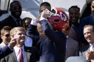 US President Joe Biden (C) takes off a Kansas City Chiefs helmet, beside Kansas City Chiefs owner Clark Hunt (L), during a ceremony welcoming the Kansas City Chiefs to the White House to celebrate their championship season and victory in Super Bowl LVIII, on the South Lawn of the White House in Washington, DC, USA, 31 May 2024