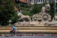 A delivery man rides a bicycle, in front of the Cibeles fountain during International Bicycle Day. International Bicycle Day is celebrated every June 3, after it was declared in 2018 by the United Nations General Assembly. (Photo by Luis Soto / SOPA Images/Sipa USA