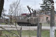 An armored Ukrainian military vehicle seen passing on the road along the private houses destroyed by Russian shelling in Orikhiv. Ukrainian President Volodymyr Zelenskyy said that he had ordered an expansion of defensive fortifications across the battlefield. Following the failure of Ukraines 2023 counteroffensive, Zelenskyys announcement may signal that Kyiv intends to adopt a defensive posture in 2024. Digging in could help Ukraine repel future Russian offensives while allowing Kyiv to spare more troops for training in the West. (Photo by Andriy Andriyenko / SOPA Images/Sipa USA