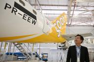 Scoot CEO Leslie Thng smiles as he looks at the E190-E2 plane decked in the airline\'s yellow and white livery, at Embraer\'s headquarters in Sao Jose dos Campos, Brazil, 10 April 2024. Scoot - the low-cost arm of national carrier Singapore Airlines,