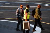 Lewis Hamilton is spotted landing in London after finishing third at the British Grand Prix . Lewis gives the pilot of his Helicopter a fist pump to thank him for the ride back to town . Lewis was accompanied by a Bodyguard for the trip . 