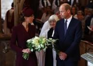*NO UK PRINT/WEB* The Prince and Princess of Wales lay flowers during a service at St David