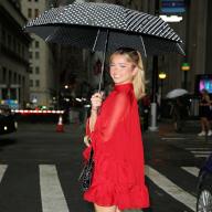 Audrey Jongens attends the alice + olivia by Stacey Bendet Spring 2024 Presentation in a red lace dress holding an umbrella in New York City Pictured: Ref: SPL9910770 090923 NON-EXCLUSIVE Picture by: Christopher Peterson / SplashNews.com 
