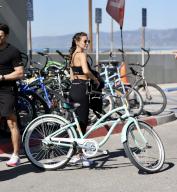 Mark Wright and Michelle Keegan, Go for a sunny bike ride in Venice CA. The two are launching a gymwear (Aytee7) company in April, and thought no better place than muscle beach to do a little beachside marketing. Pictured: Mark Wright,Michelle 
