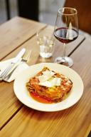 Lasagne with parmesan and a glass of red wine