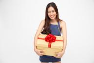 Happy asian woman smile with gold gift box isolated on white background. Teenage girls in love, Receiving gifts from lovers. New Year, Christmas and Valentines Day concept