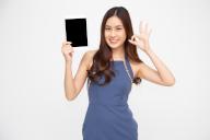 Happy asian woman holding tablet and ok sign isolated on white background