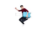 Young Asian man jumping with suitcase travel bag isolated on white background