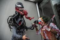Fans of Marvel and Comics in general pose for a photo while using the VENOM costume during the fourth day of the SOFA (Salon del Ocio y la Fantasia) 2021, a fair aimed to the geek audience in Colombia that mixes Cosplay, gaming, superhero and movie 