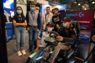 People play and enjoy a driving simulator from Logitech during the fourth day of the SOFA (Salon del Ocio y la Fantasia) 2021, a fair aimed to the geek audience in Colombia that mixes Cosplay, gaming, superhero and movie fans from across Colombia, 