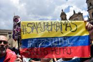 People hold Colombian flags and banners as Colombians march in support for the government proposed social reforms in Bogota, Colombia, September 27, 2023