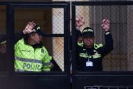Two police officers of the Colombian Congress building watch behind a fence as Colombians march in support for the government proposed social reforms in Bogota, Colombia, September 27, 2023